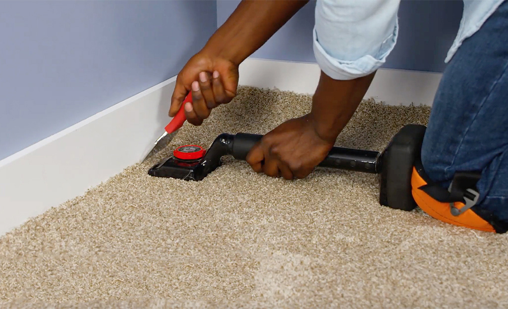 Carpet installer fitting carpet in a Downtown Dubai apartment